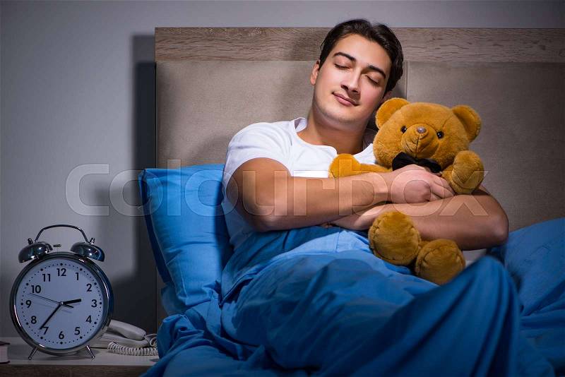 The young man sleeping in the bed, stock photo