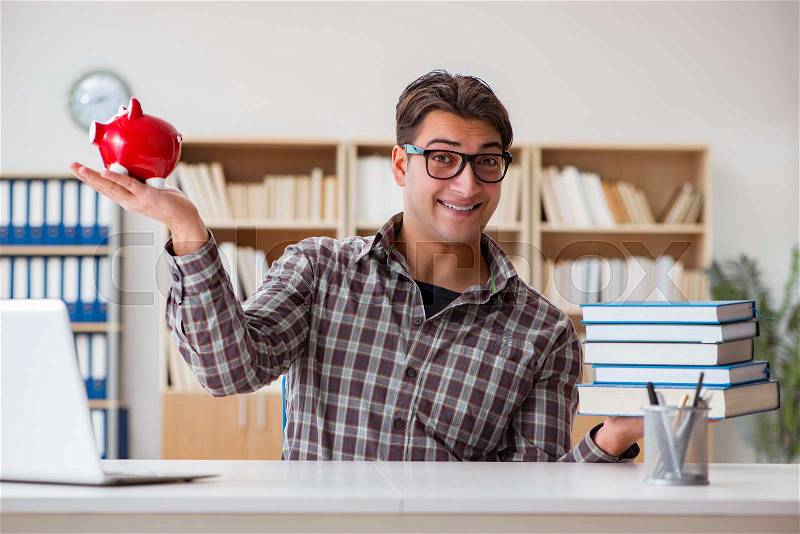 The young student breaking piggy bank to buy textbooks, stock photo