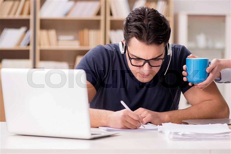 The young student drinking coffee from cup, stock photo