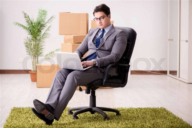 The businessman sitting on the chair in office, stock photo
