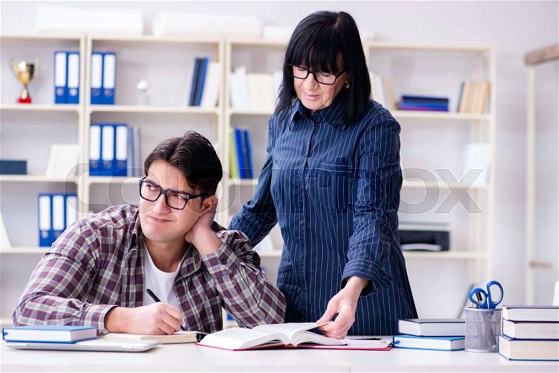 The young student during individual tutoring lesson, stock photo