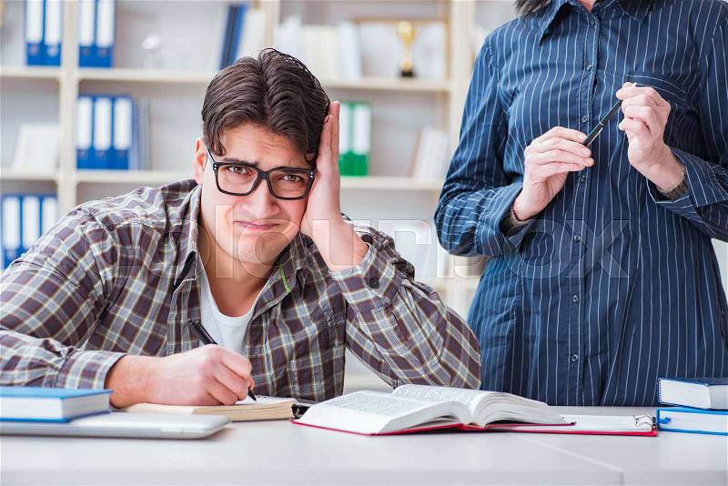 The young student during individual tutoring lesson, stock photo