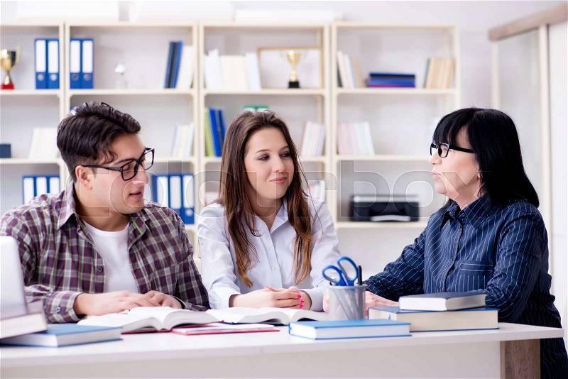 The young student and teacher during tutoring lesson, stock photo