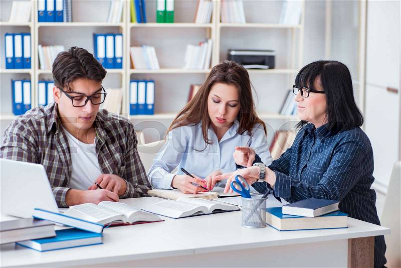The young student and teacher during tutoring lesson, stock photo