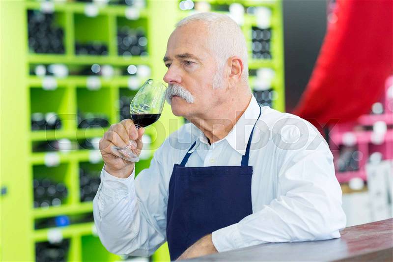 Sommelier smelling wine, stock photo