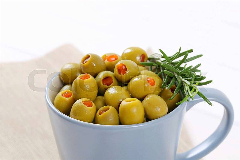 Cup of green olives stuffed with red pepper - close up, stock photo