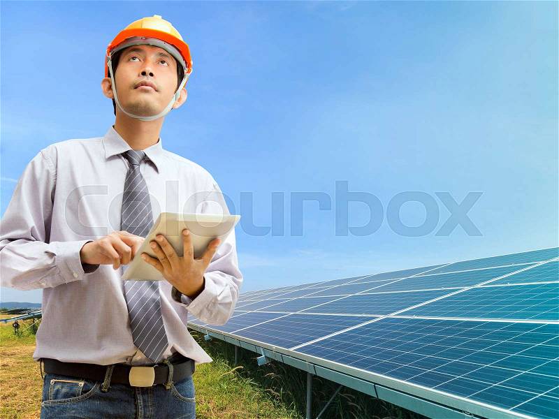 Engineers using digital tablet working and checking at industry solar power, stock photo