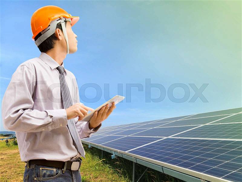 Engineers using digital tablet working and checking at industry solar power, stock photo