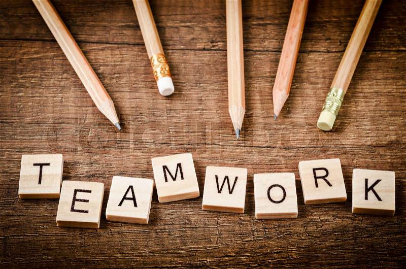 TEAMWORK word written on wood block with wood pencils on wooden background. , stock photo