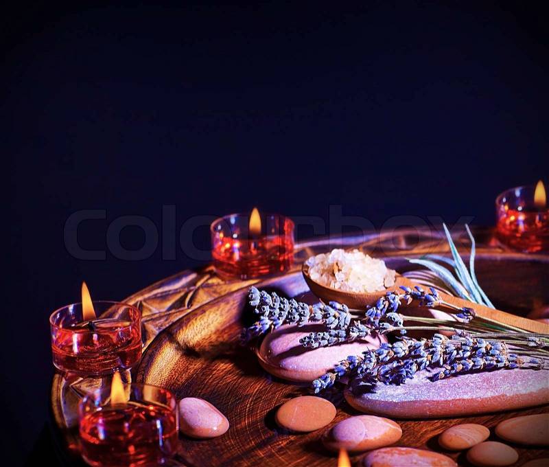 Lavender herbal spa still life, warm candle light and zen stones, relaxation and beauty treatment concept, stock photo