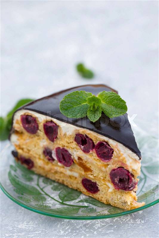 Cake with cherry, cream and chocolate icing, stock photo