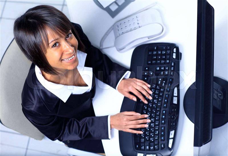 Top view of a happy female business executive working on laptop, stock photo