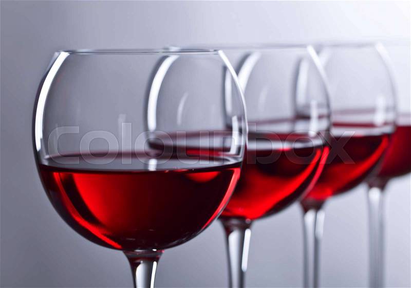 Glasses of red wine on a dark background, stock photo