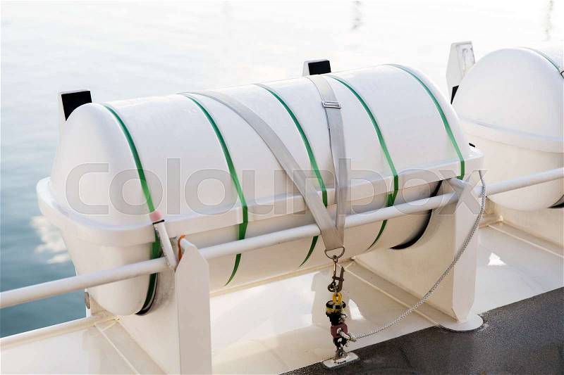Shipping, rescue and sailing concept - life raft container on ship or boat deck, stock photo