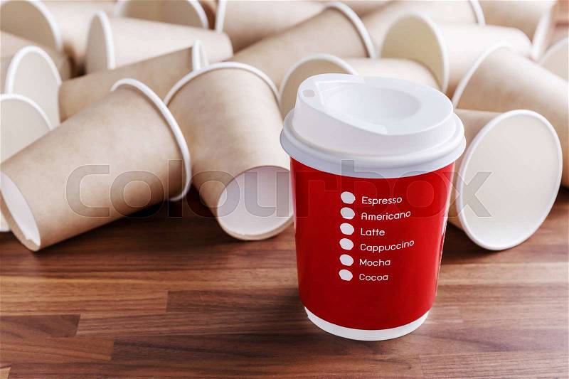 Red paper coffee cup with brown paper cups background, stock photo