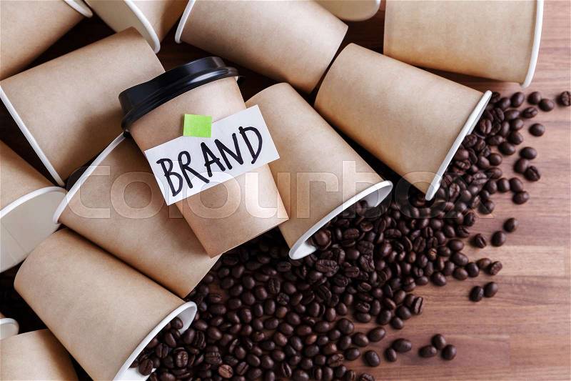 Coffee identity brand building concept with coffee beans and lots of paper coffee cups background, stock photo