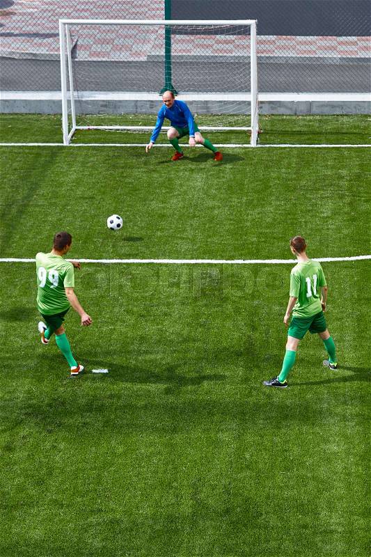 Soccer football goalkeeper making diving save on green fuild, stock photo