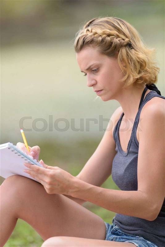 Women write note at outdoor in the garden, stock photo