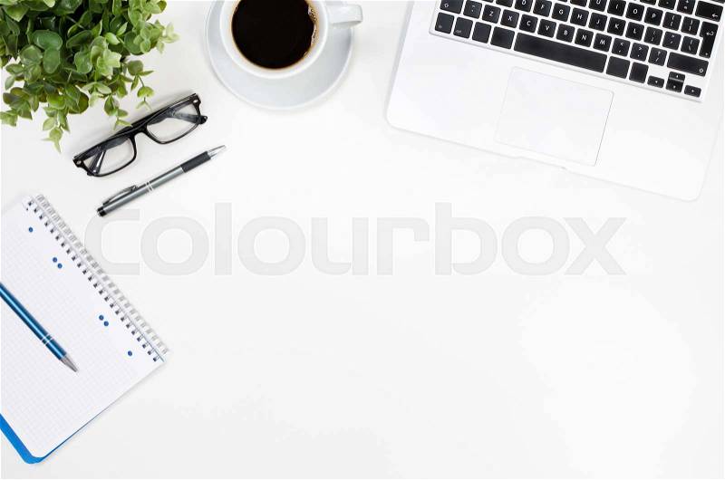 Office desk table with laptop, coffee cup and office supplies top view, stock photo