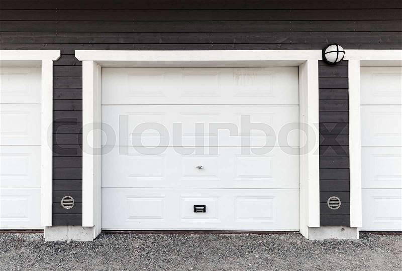 White garage wall with white closed gates, background photo texture, stock photo