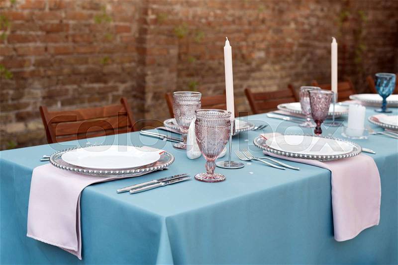 Table decorations for holidays and wedding dinner. Table set for holiday, event, party or wedding reception in outdoor restaurant, stock photo