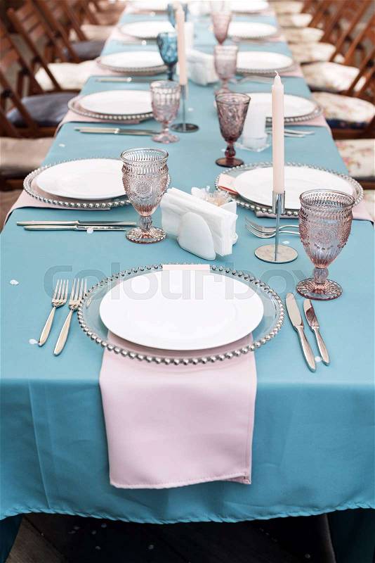 Table decorations for holidays and wedding dinner. Table set for holiday, event, party or wedding reception in outdoor restaurant, stock photo