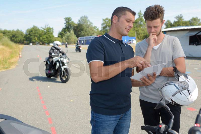 Student and professor - motorbike lesson, stock photo
