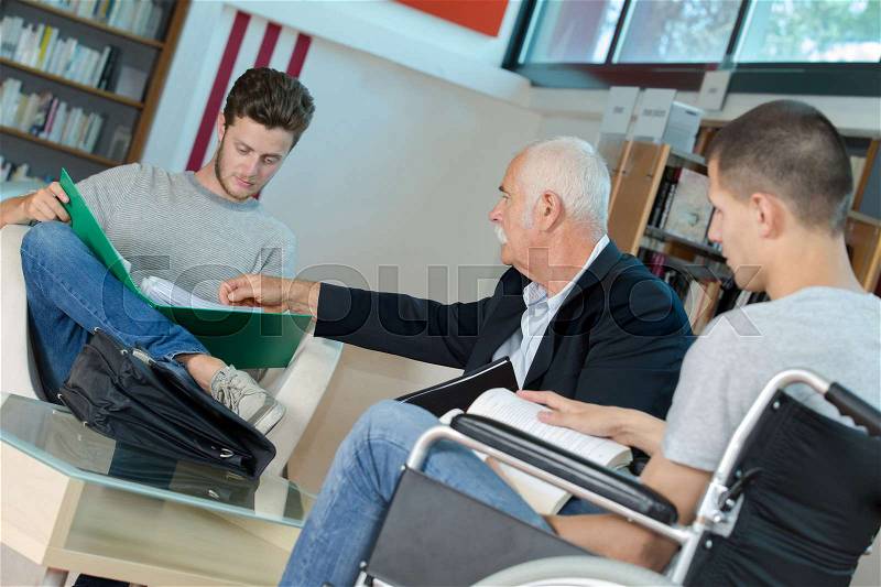 Students in meeting with teacher, stock photo