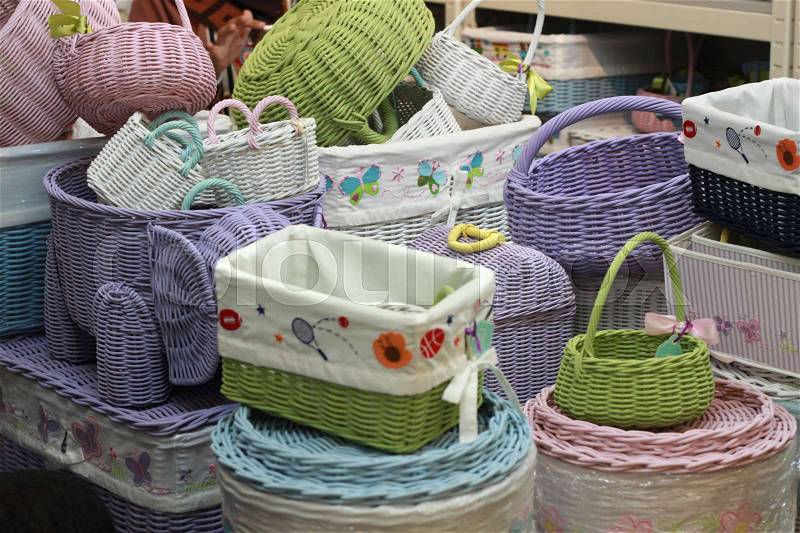 Various rattan basket stacked in store. handmade straw woven container colorful, stock photo