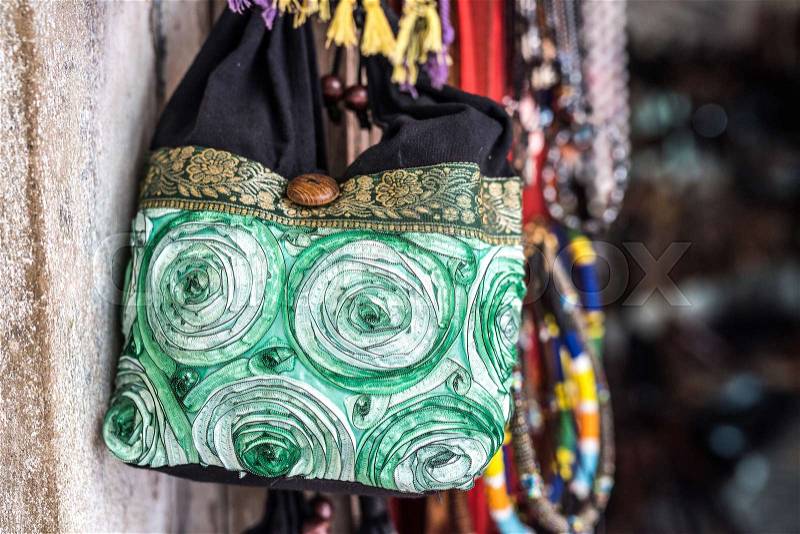Handmade fabric bag hung on a wall for sale in african market street, stock photo