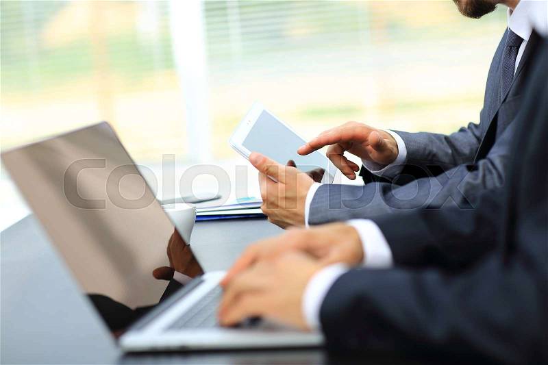 Business people working with digital tablet and laptop at office, stock photo