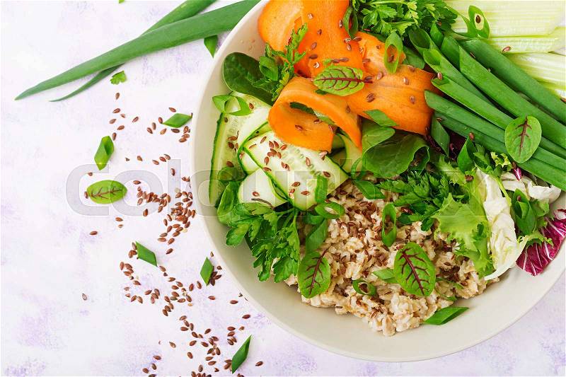 Diet menu. Healthy lifestyle. Oat porridge and fresh vegetables - celery, spinach, cucumber, carrot and onion on plate. Flat lay. Top view, stock photo