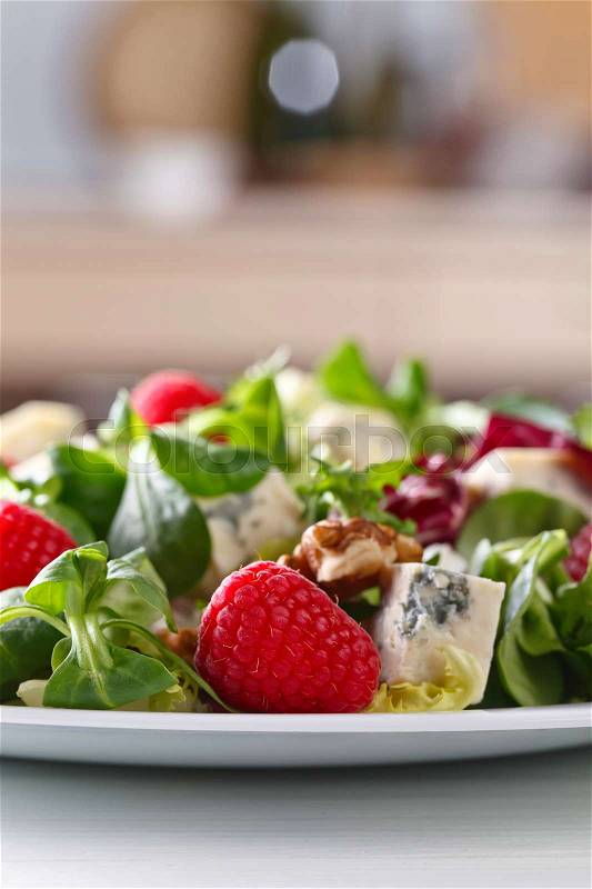 Green salad with blue cheese , raspberry and walnuts, stock photo