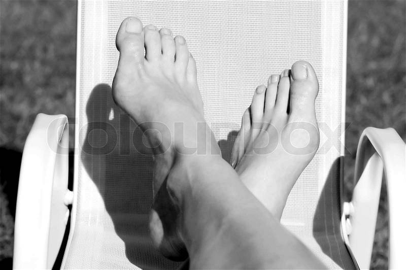 Relax - female feet on the little green chair, stock photo