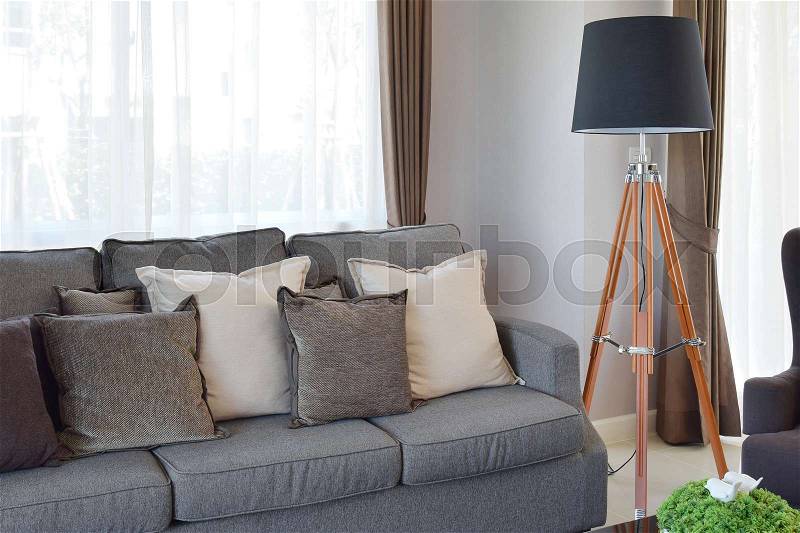 Modern living room design with sofa and wooden lamp, stock photo