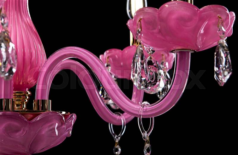 Contemporary pink glass crystal chandelier isolated on black background. close-up chandelier, stock photo