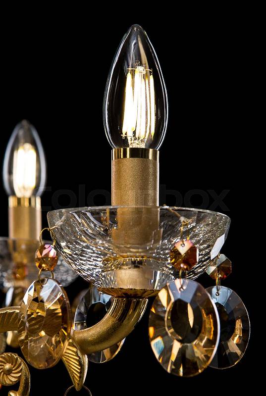Contemporary glass crystal chandelier isolated on black background. close-up chandelier, stock photo