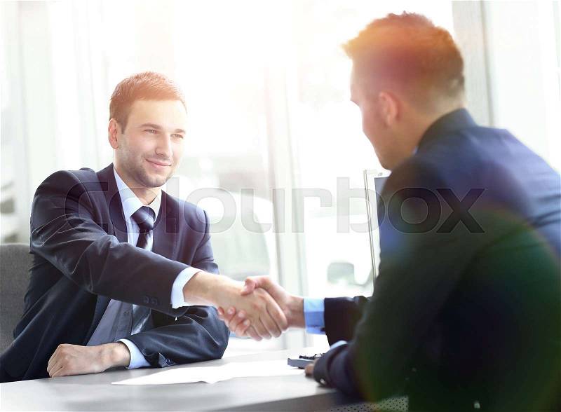 businessman shaking hands to seal a deal with his partner, stock photo