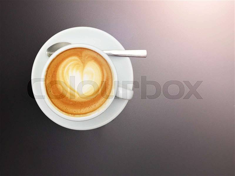Topview of white cup with flat white coffee topped with heart shaped latte art, stock photo
