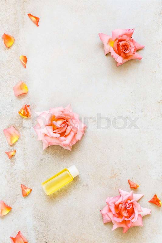 Aromatherapy rose massage oil. Rose flower and essential oils, spa and aromatherapy still life. Top view, rustic surface, blank space, stock photo