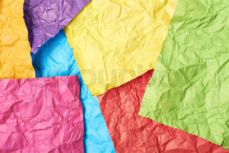 Surface coated with the multiple colorful crumpled origami paper sheets as an abstract background composition, stock photo