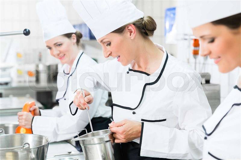 Team of chefs in production process of system catering, stock photo