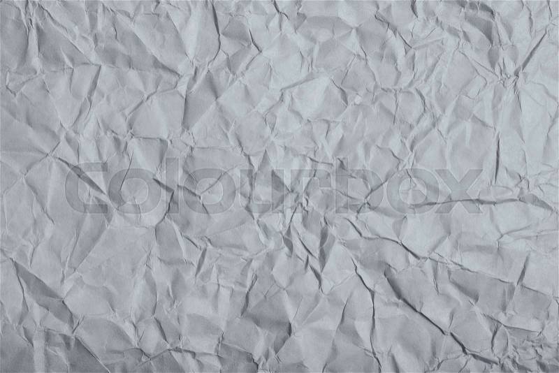 Close-up fragment of a gray crumpled paper texture as a backdrop composition, stock photo