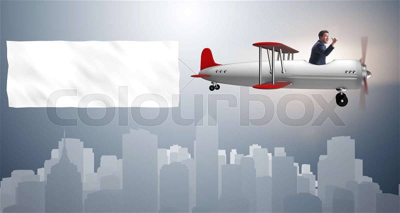 Biplane with businessman and blank banner, stock photo