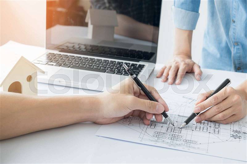 Architects engineer discussing at the table with blueprint - Closeup on hands and project print, Team group on construciton site check documents and business workflow, stock photo