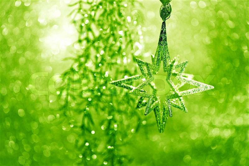 Shiny silver star with green lights on shimmer festive background, stock photo