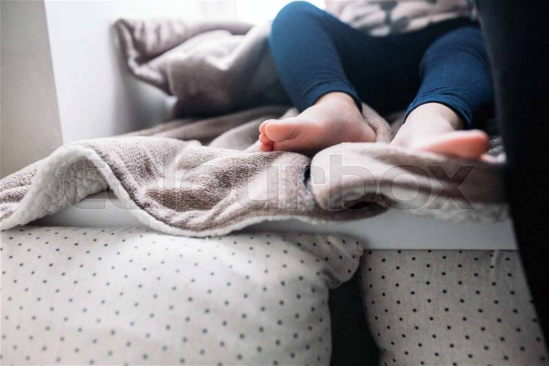 The legs of a little girl, indoors, stock photo