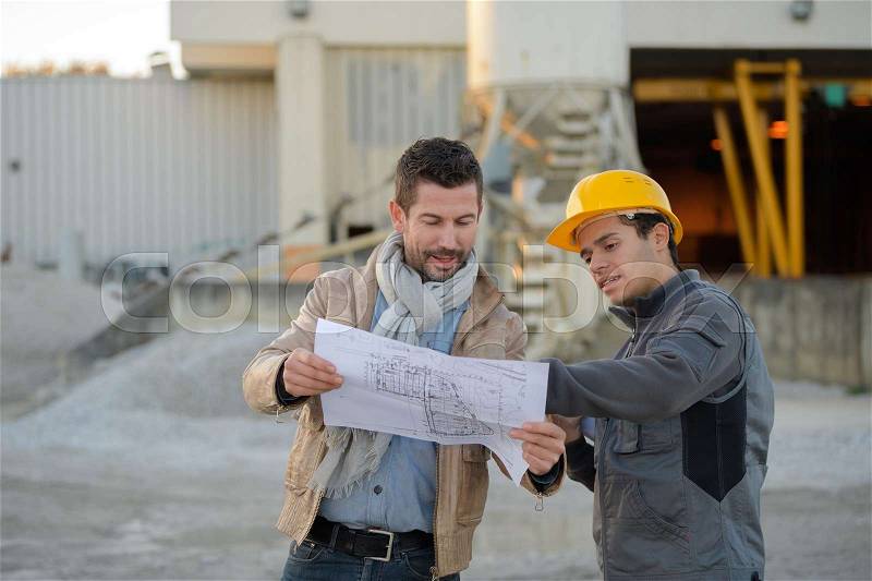 Engineers outside an electrical industry, stock photo