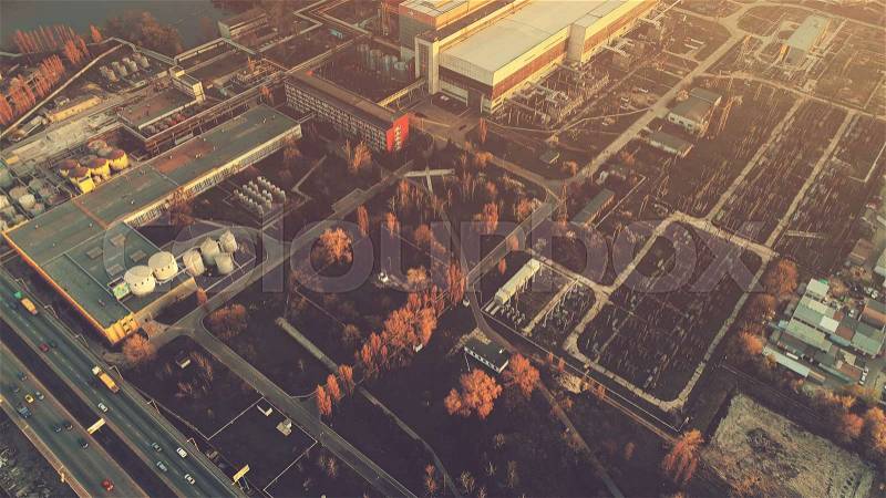 Aerial Drone Flight Photo over industrial zone of Kiev, Ukraine. Urban buildings, factory, power plant. Top view. Instagram vintage filter toning. Abstract futuristic cityscape in sunset soft light, stock photo