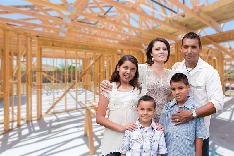 Young Hispanic Family On Site Inside New Home Construction Framing, stock photo